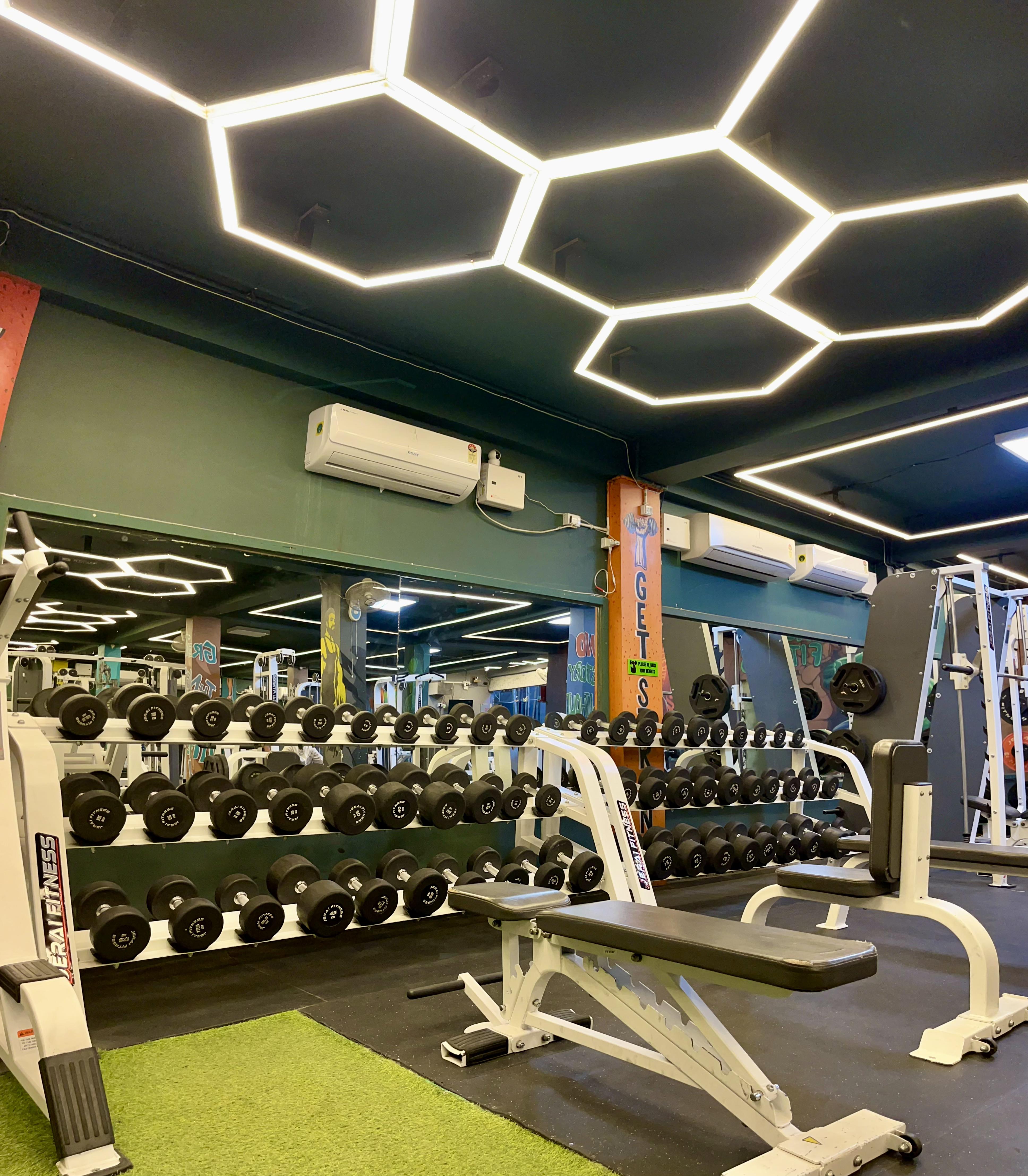 Hulk Fitness dumbbell rack with premium JERAI equipment and hexagonal LED ceiling lights